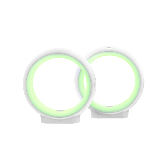 Two white circular LuvLink Infinity friendship lamps glowing with soft green light rings side by side.
