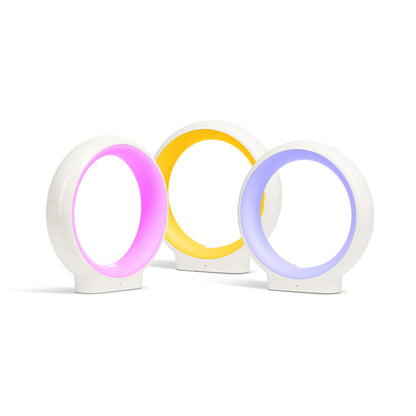 Three white oval LuvLink Infinity friendship lamps glowing in magenta, yellow, and blue against a white background.